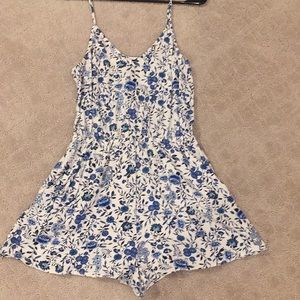 White romper with blue floral print and pockets